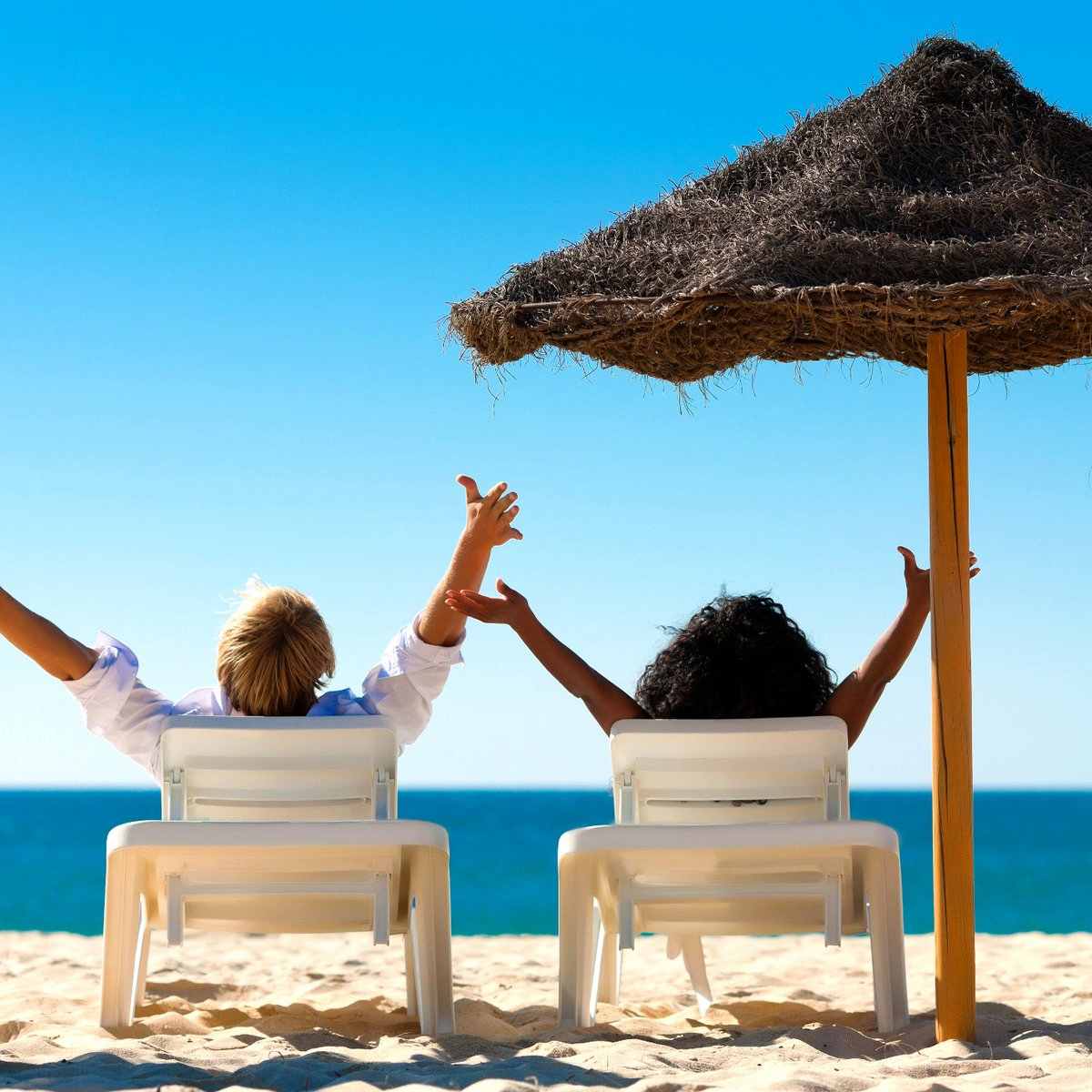Couple relaxing on an Australian beach with Where To Enjoy benefits